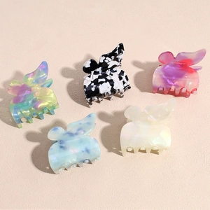 Set of five colorful acetic acid butterfly hair claws in various marble and floral patterns
