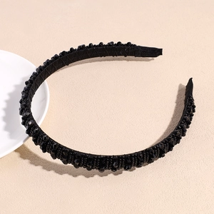 Detailed view of the black beaded headband with non-slip texture and elegant craftsmanship