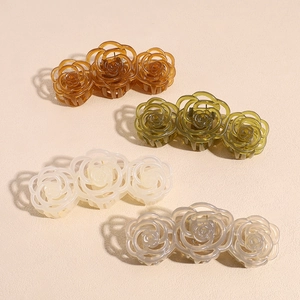 Elegant 3-rose resin hair claw clips for women in four colors on a textured beige background