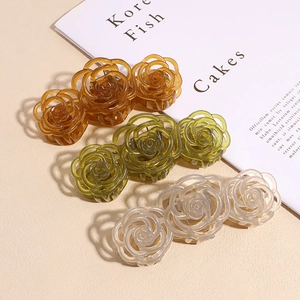 Three elegant rose hair claws in amber, olive, and cream translucent resin finish