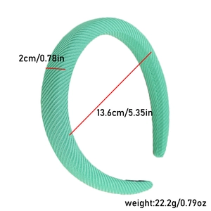 Detail of mint green ribbed fabric headband showing 2cm width and 13.6cm inner diameter