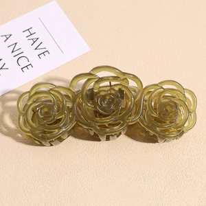 Close-up of olive green resin rose hair claw clip with elegant hollow-out floral details