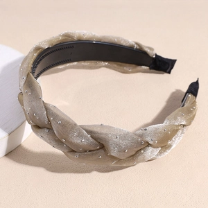 Detail view of champagne gold braided headband with rhinestones and non-slip teeth