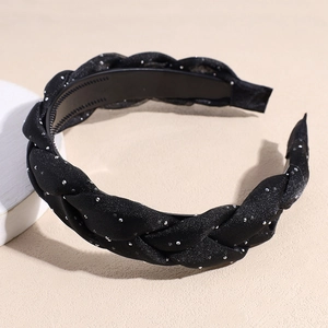 Detail of black braided headband with silver glitter and anti-slip teeth on inner band