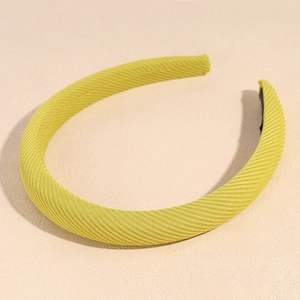Detail of padded lemon green headband featuring thick knit texture and soft lining