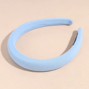 Detailed view of the baby blue fabric texture and thick padding on the minimalist headband
