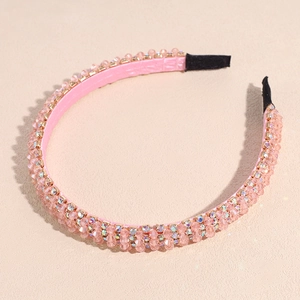 Detail of light pink beaded headband with sparkling crystals and a faux leather finish