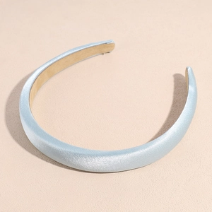 Detail of light blue padded satin headband featuring smooth silk-like texture and finish