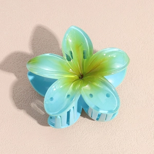 Detail of plumeria hair claw clip with gradient blue and yellow translucent petals
