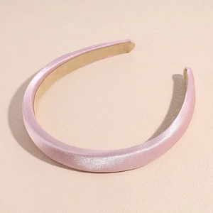 Detail of light pink satin headband with thick sponge padding and non-slip inner lining