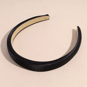 Close-up of black satin padded headband showing inner anti-slip lining and texture