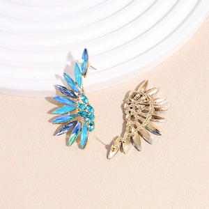 Dramatic wing shaped earrings with blue gradient crystals on a golden base
