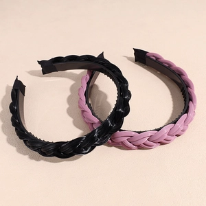 Elegant woven headband with non-slip teeth in black and purple colors on a beige base