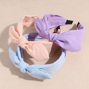 Three solid color chiffon bow headbands in light purple, pink, and light blue with soft fabric
