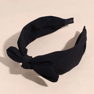 Detail of a black chiffon bow headband with a wide textured fabric and vintage knot design