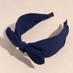 Close-up of navy blue chiffon bow headband with detailed fabric texture and nonslip ends
