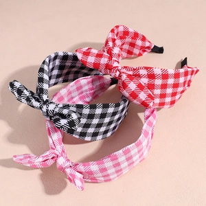 Three plaid bunny ear headbands in red, black, and pink fabric for hair styling