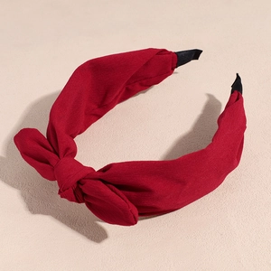 Detail of dark red chiffon bow headband showing fabric texture and comfort end tips