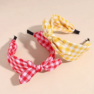 Plaid bunny ear headbands in red and yellow fabric with bow detail for women