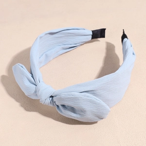 Detail of light blue chiffon bow headband showing the soft texture and wide frame design