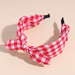 Close-up of red and white checkered fabric headband featuring a cute knotted bow design
