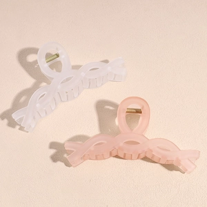 Matte finish twist hair claws in cream and pale orange pink for elegant hair styling