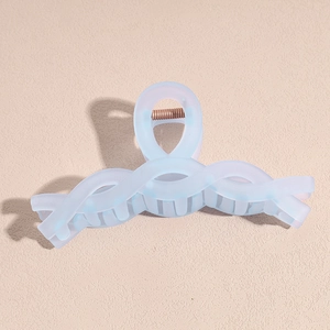 Matte light blue shark hair claw clip with a sleek twisted design and metal spring