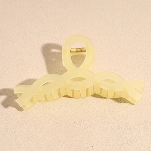 Detail shot of large matte cream hair claw clip with strong metal spring and teeth