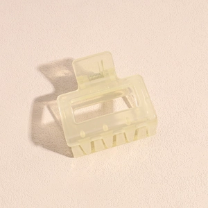 Detail of a translucent cream yellow square hair claw clip with a durable metal spring