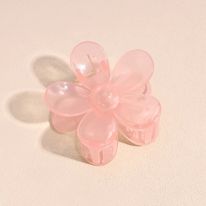 Detail showing high-quality pink 5-petal flower hair claw clip with golden metal spring
