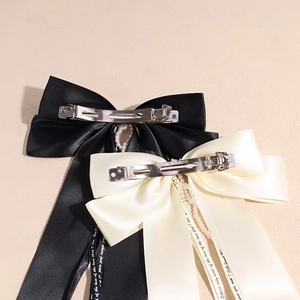Elegant large satin bow hair clip with long ribbons and pearl chain detail