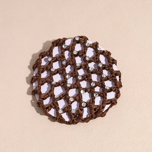 Close-up of brown bun cover hair net with sparkling white rhinestones on purple base