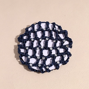 Detailed view of dark blue woven hair net featuring sparkling rhinestone accents on mesh