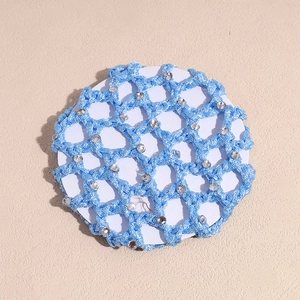 Detail of light blue mesh hairnet with small sparkling rhinestones on a card base