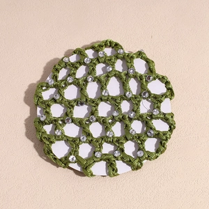 Detail of crochet hair net in grass green with clear rhinestones for ballet and nurse buns