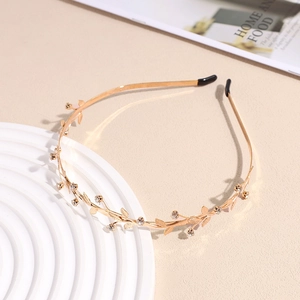 Elegant gold twig and leaf headband with pearls and rhinestones for a stylish look
