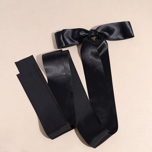 Elegant long black satin bow hair clip with ribbons in a minimalist balletcore style
