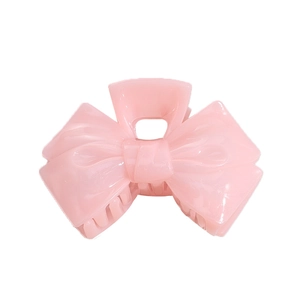 Elegant jelly pink acrylic bow hair claw clip with smooth glossy finish on white background