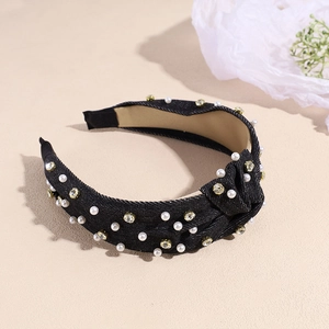 Detail shot of black denim headband with embedded faux pearls and glittering rhinestones