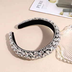 Close-up of sparkling clear rhinestones on a black sponge padded wide headband