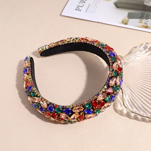 Detail of a baroque headband with colorful rhinestones on a thick black fabric base