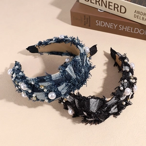 Blue and black plaid denim headbands with pearls and rhinestones on a beige surface
