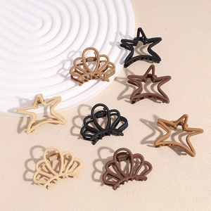 Chic matte metal claw clips in star and wave shapes across earthy neutral tones