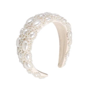 Baroque padded headband with faux pearls in creamy white on a minimalist white background