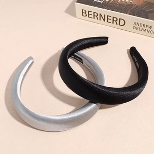 Two-piece set of thick satin sponge headbands in black and silver with a smooth glossy finish