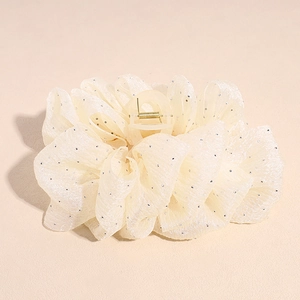 Détail d'une pince à cheveux en organza crème avec tissu plissé et paillettes argentées