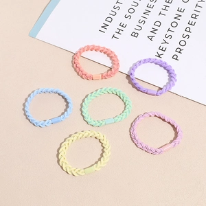 Set of 6 colorful braided elastic hair ties in pastel candy colors on neutral background