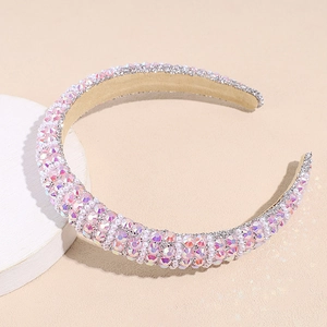 Close-up of pink rhinestones and white pearls on a padded Baroque sponge headband