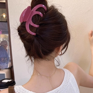 Vue détaillée d'une grande pince à cheveux violette brillante sur un chignon à la française