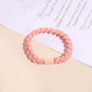 Close-up of pink braided hair tie with elastic weave and matching resin buckle